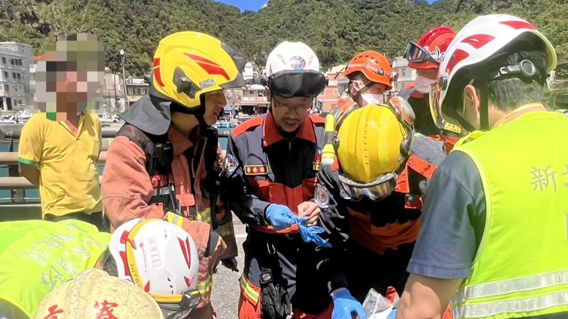 亞東醫院醫師夏肇聰(中)抵達現場,協助警消救援李男脫困。新北市消防局提供