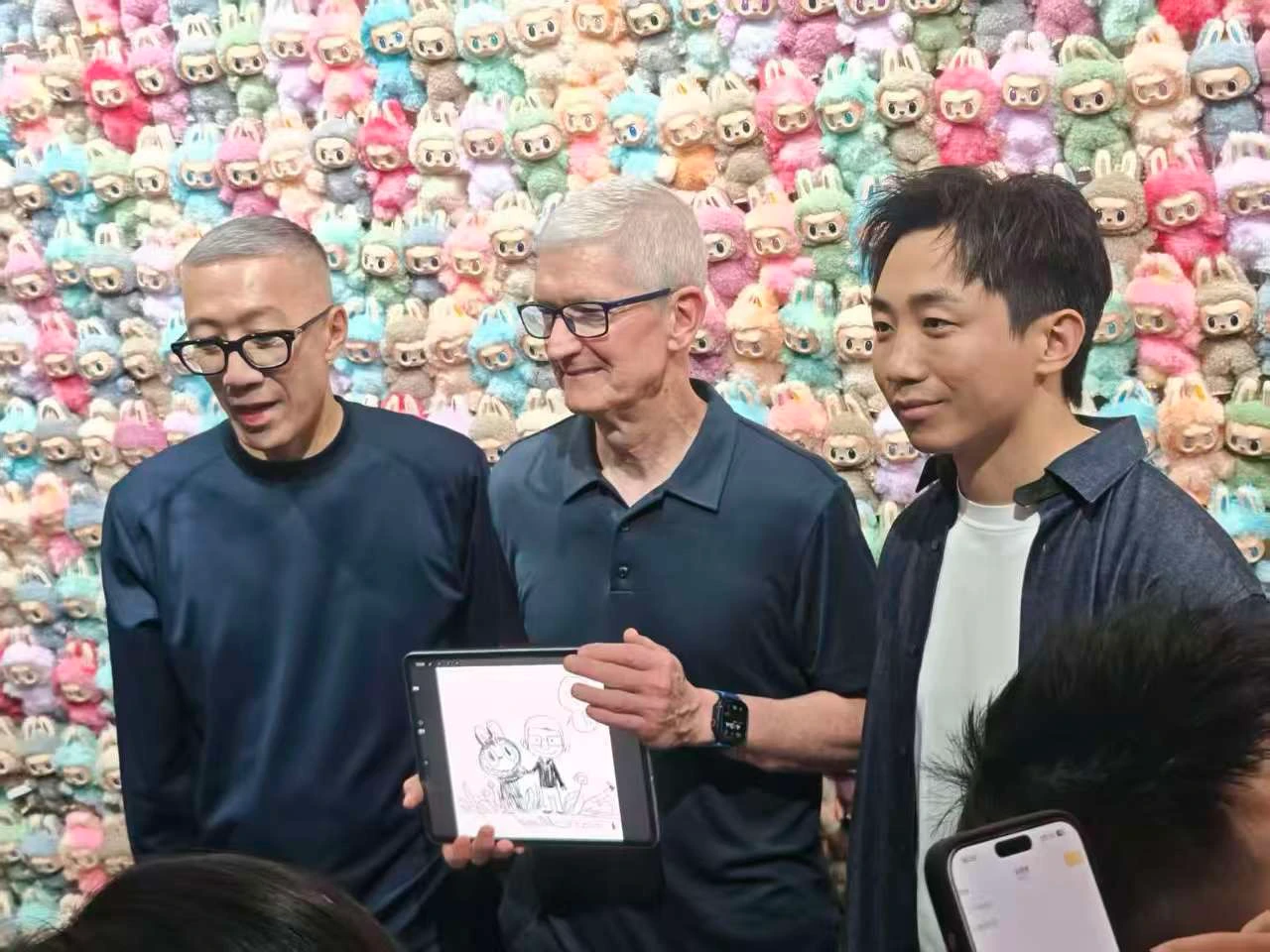 龍家昇(左)向庫克(中)展示如何在iPad Pro上繪製Labubu;右為王寧。泡泡瑪特提供